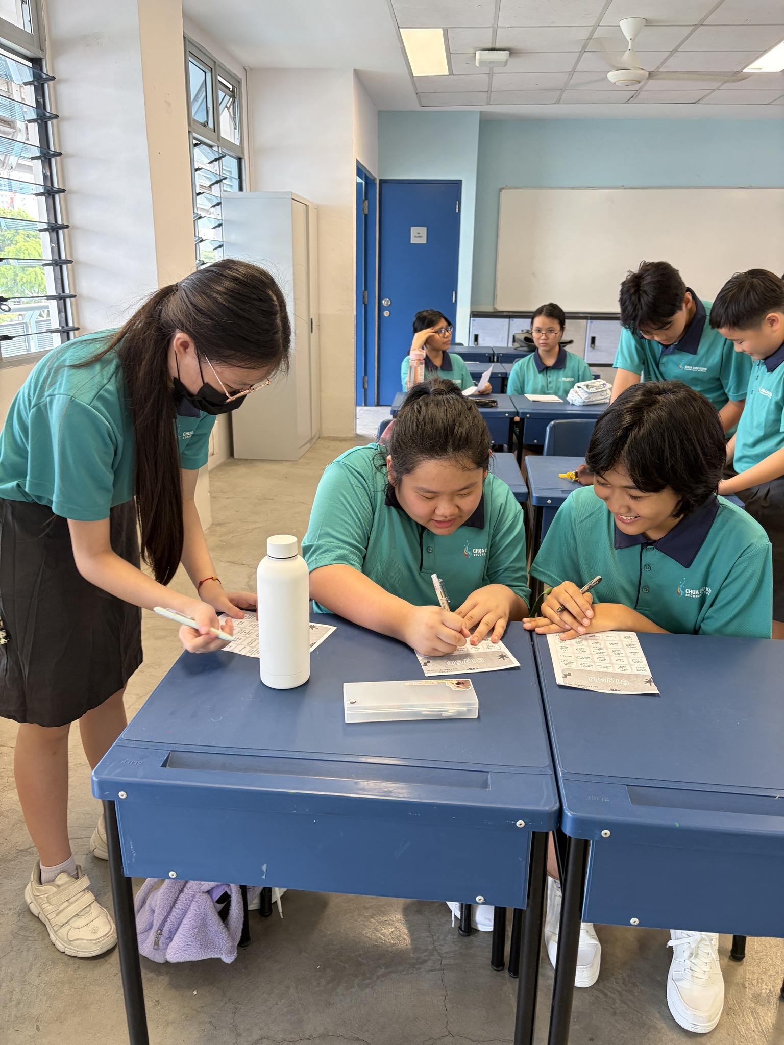 students sit writing at tables
